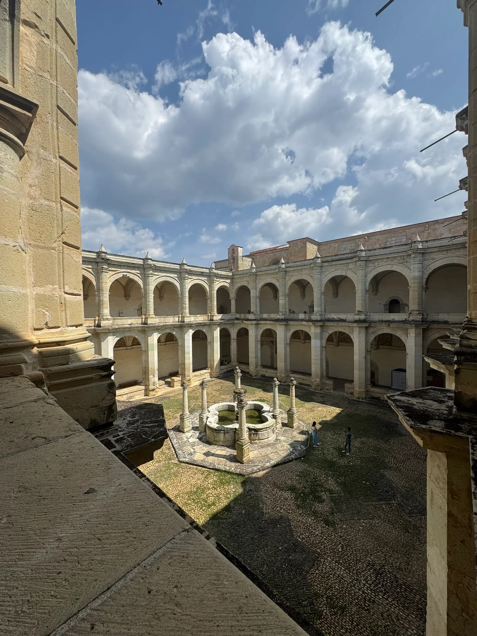 Two-storey arcaded cloister and octagonal stone fountain at the former Santo Domingo monastery, Oaxaca
