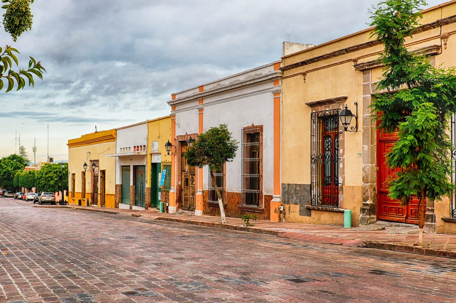 A cobbled street of painted colonial housefronts in the historic centre of Queretaro