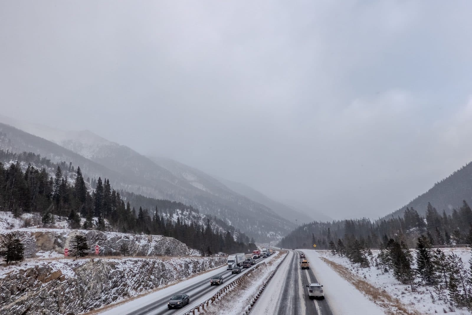 Traffic on Interstate 70 through the Colorado Rockies during winter snowfall