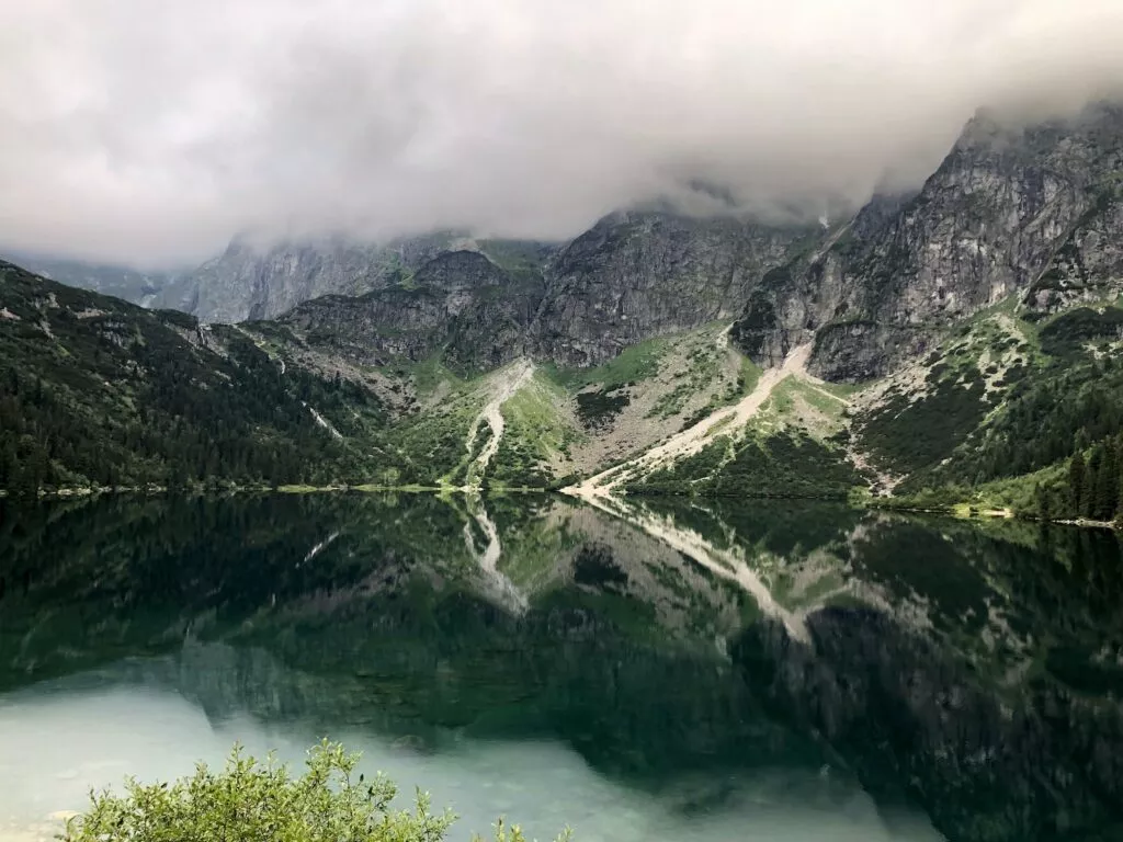 Green and gray mountains near body of water during daytime