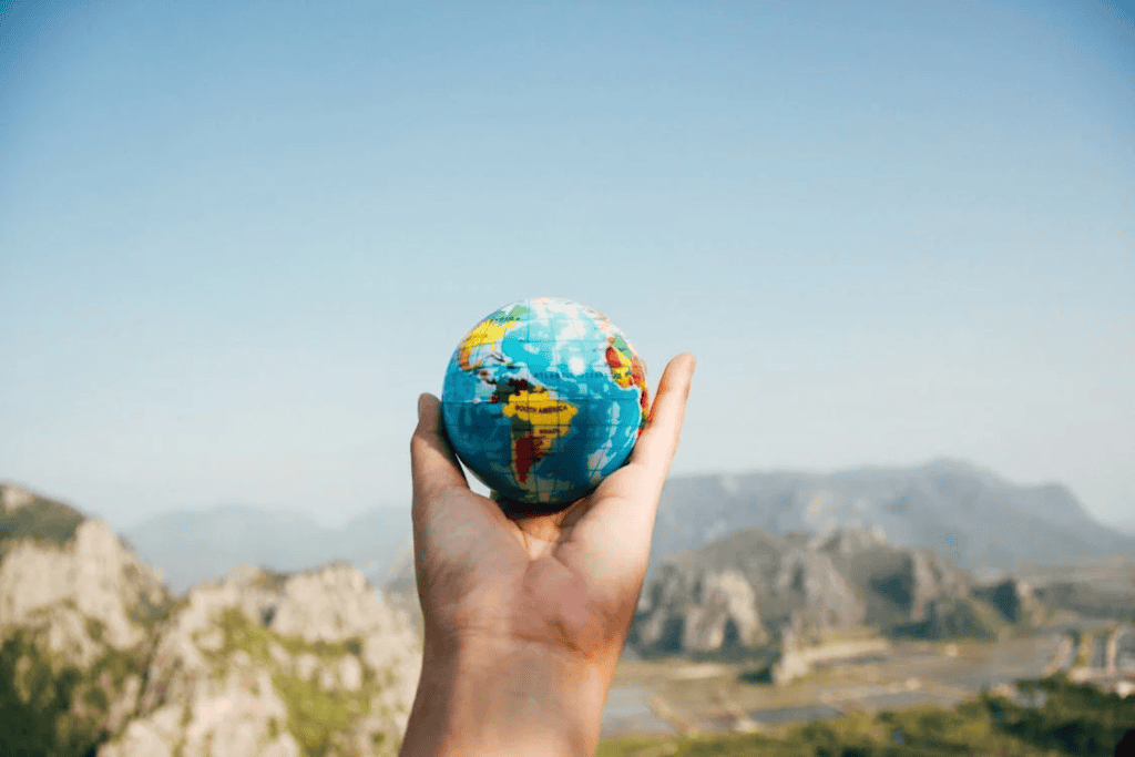 Hand holding a travel globe