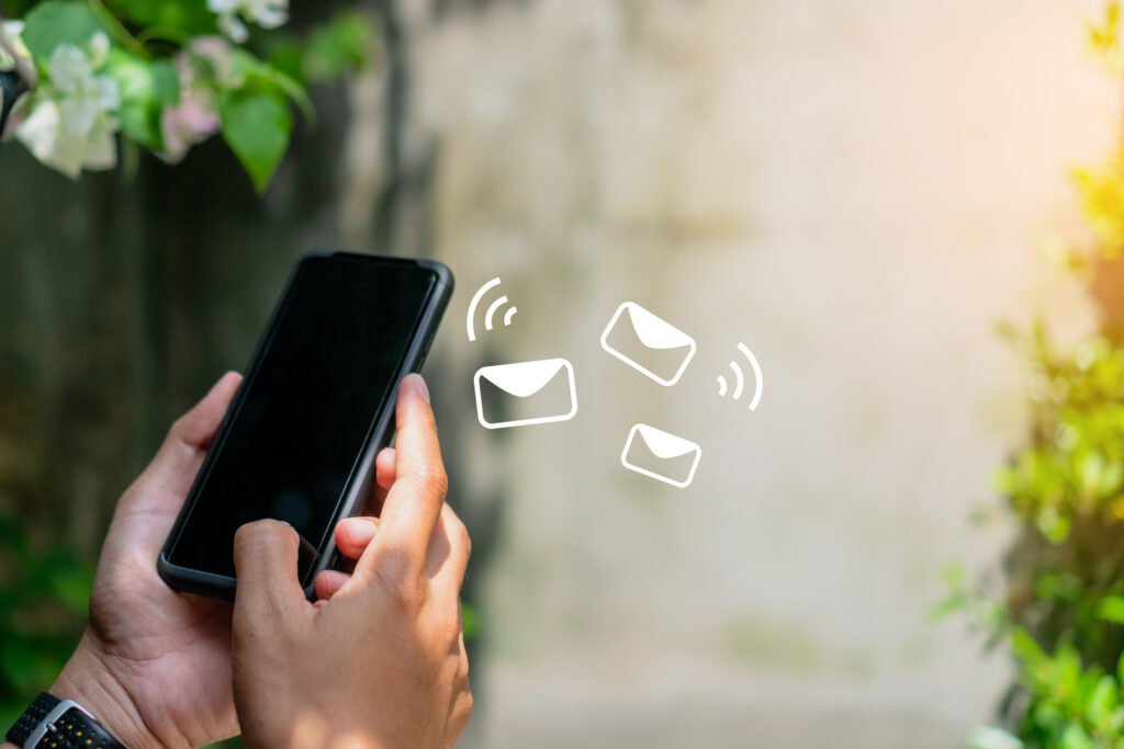Woman hand using smartphone and it's show email receive notification icon pop up on screen of mobile phone.