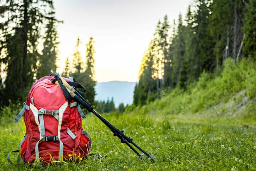 Hiking backpack with trekking poles for mountain hiking.